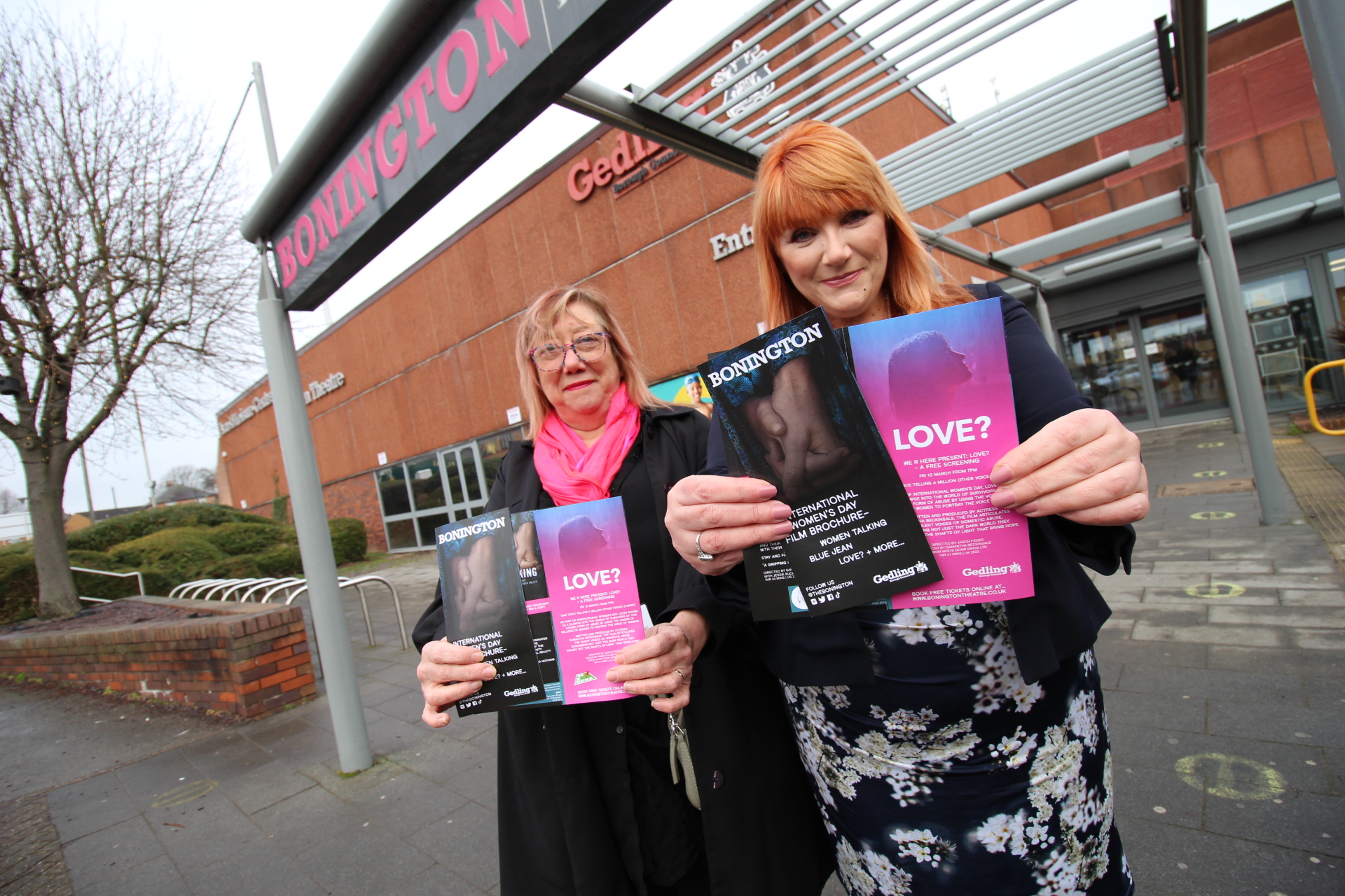 Hilary Brown and Kathryn Fox holding a flyer promoting the film outside the Bonington