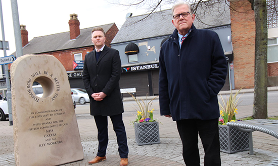 John and Michael standing next to memorial stone