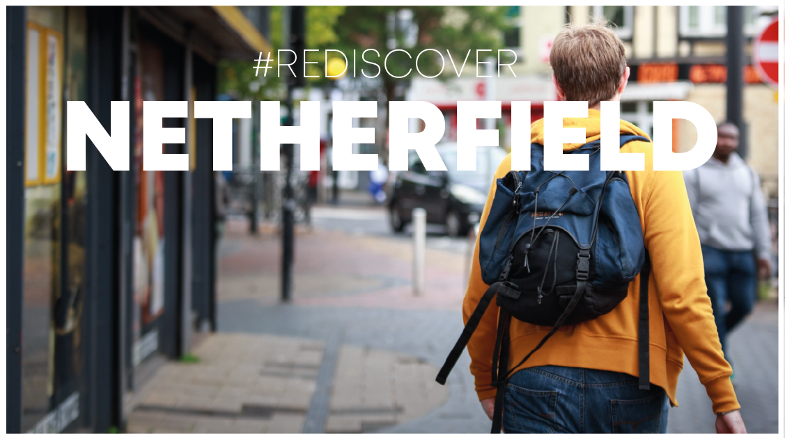  a person in a yellow coat with a backpack walking away down a high street with Rediscover Netherfield over the image