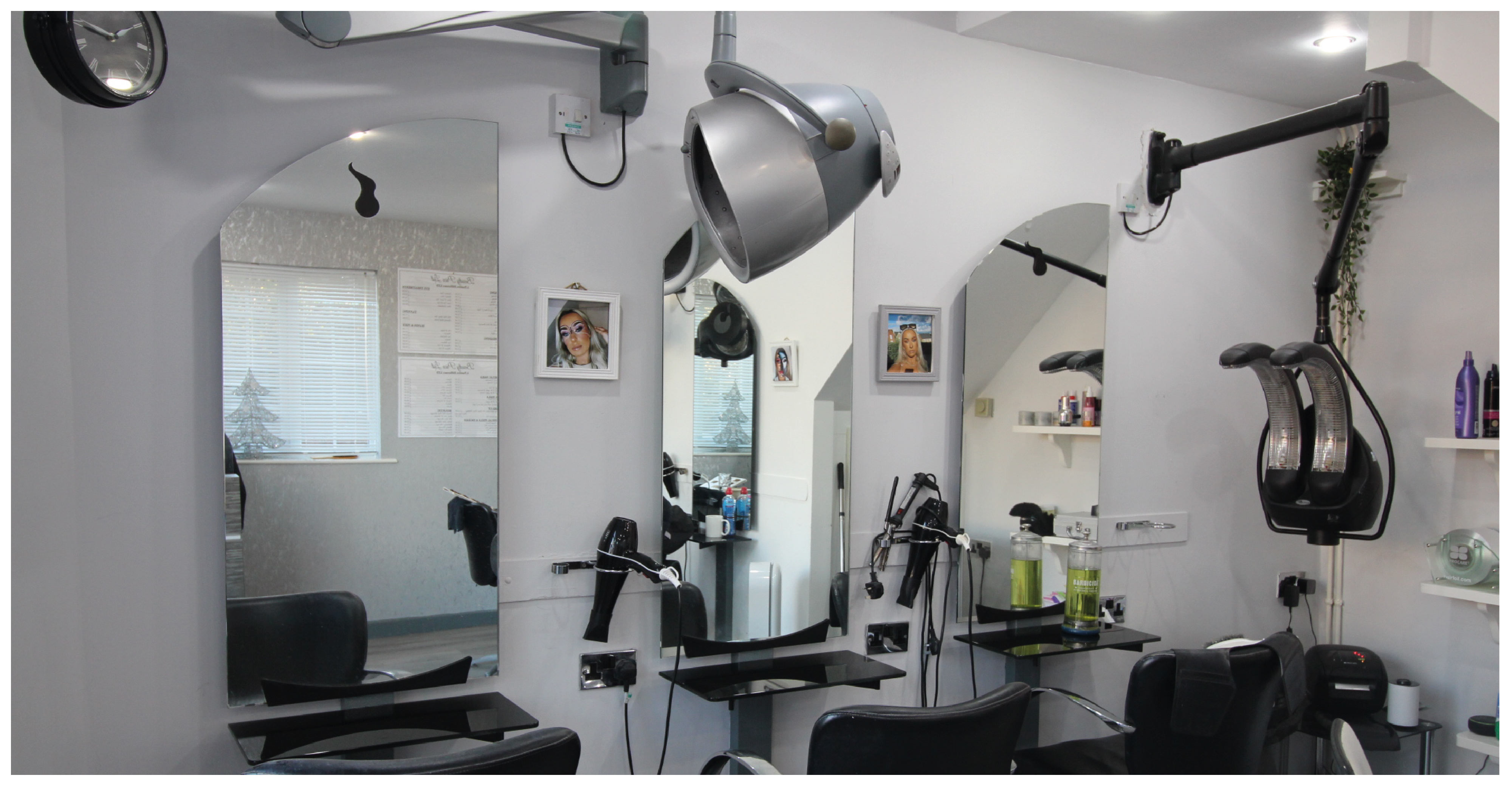the inside of a beauty salon with chairs and hairdryers