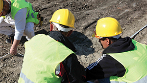 people on a building site wearing high vis jackets and safety helmets