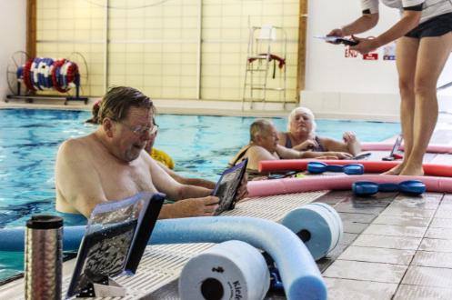 Good Boost man using tablet in the swimming pool